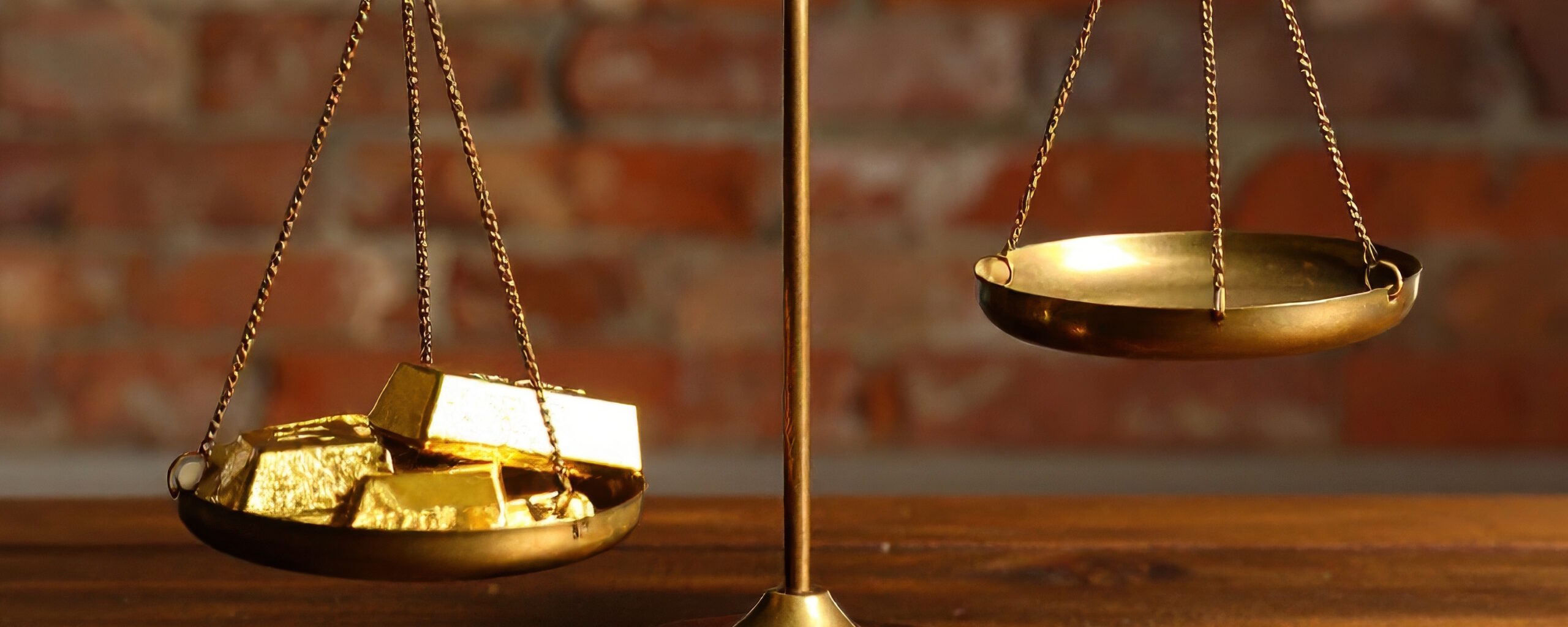 Balance scale with gold bullion